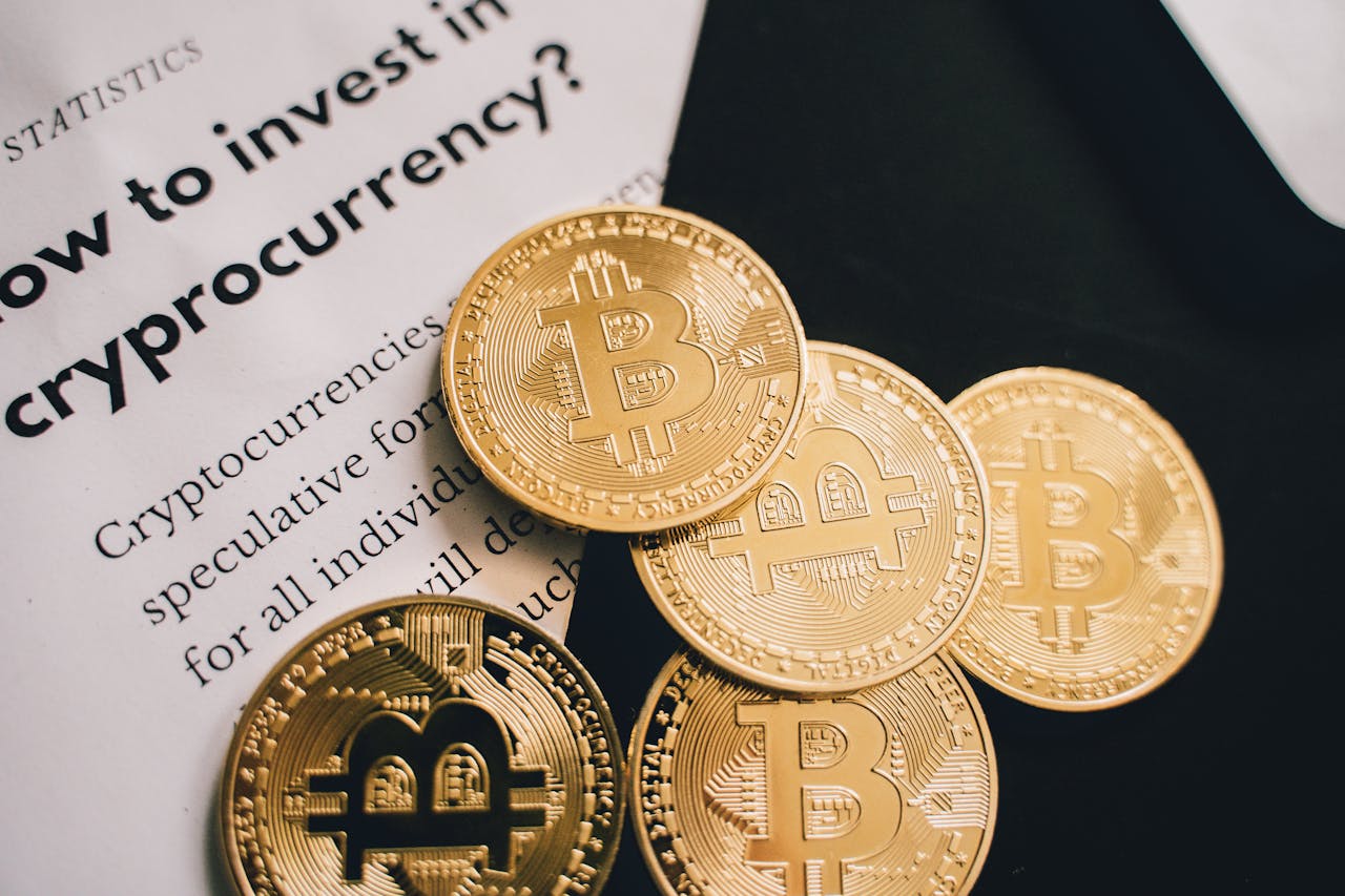 Close-up of Bitcoin coins alongside an investment guide in cryptocurrency.